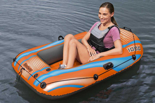 Ponton Kondor Elite 1000 Bestway orange and blue inflatable boat with woman sitting inside on calm water