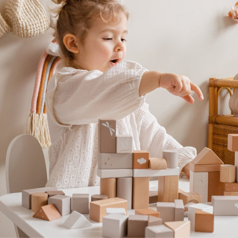 Child playing with Label Label wooden blocks set in natural and nougat colors on table