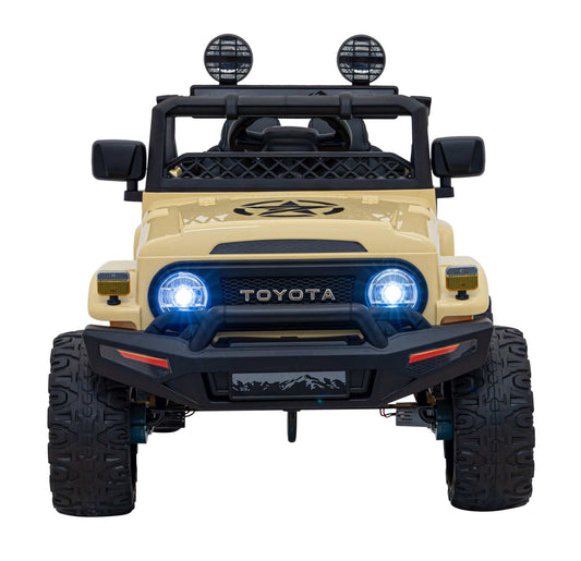 Beige Toyota FJ Cruiser kids' electric car with 4x4 drive, LED lights, audio, EVA wheels, and remote control