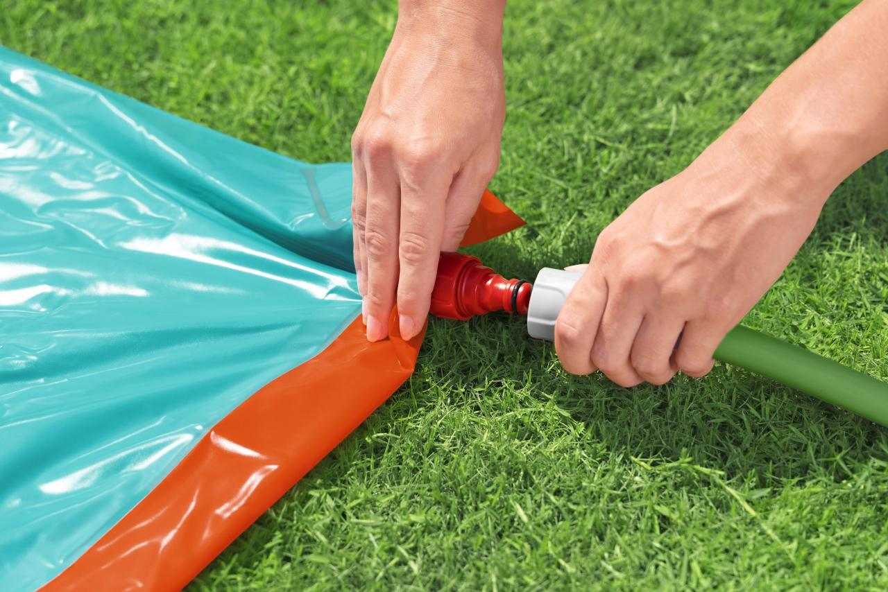 Podłączanie węża ogrodowego do pojedynczego ślizgu H2OGO StompBlast na trawie