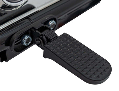 Close-up of black foot pedal on Pojazd Motorek Chopper Warrior children's electric motorcycle with textured surface and hinge mechanism