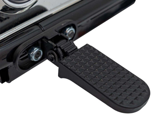 Close-up of black foot pedal on Pojazd Motorek Chopper Warrior children's electric motorcycle with textured surface and hinge mechanism