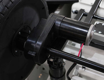 Close-up of motor and wheel assembly in Mercedes Benz G63 AMG XXL electric ride-on car for kids, black model.