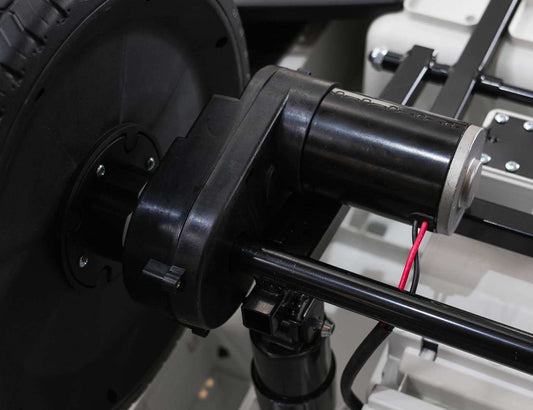 Close-up of motor and wheel assembly in Mercedes Benz G63 AMG XXL electric ride-on car for kids, black model.