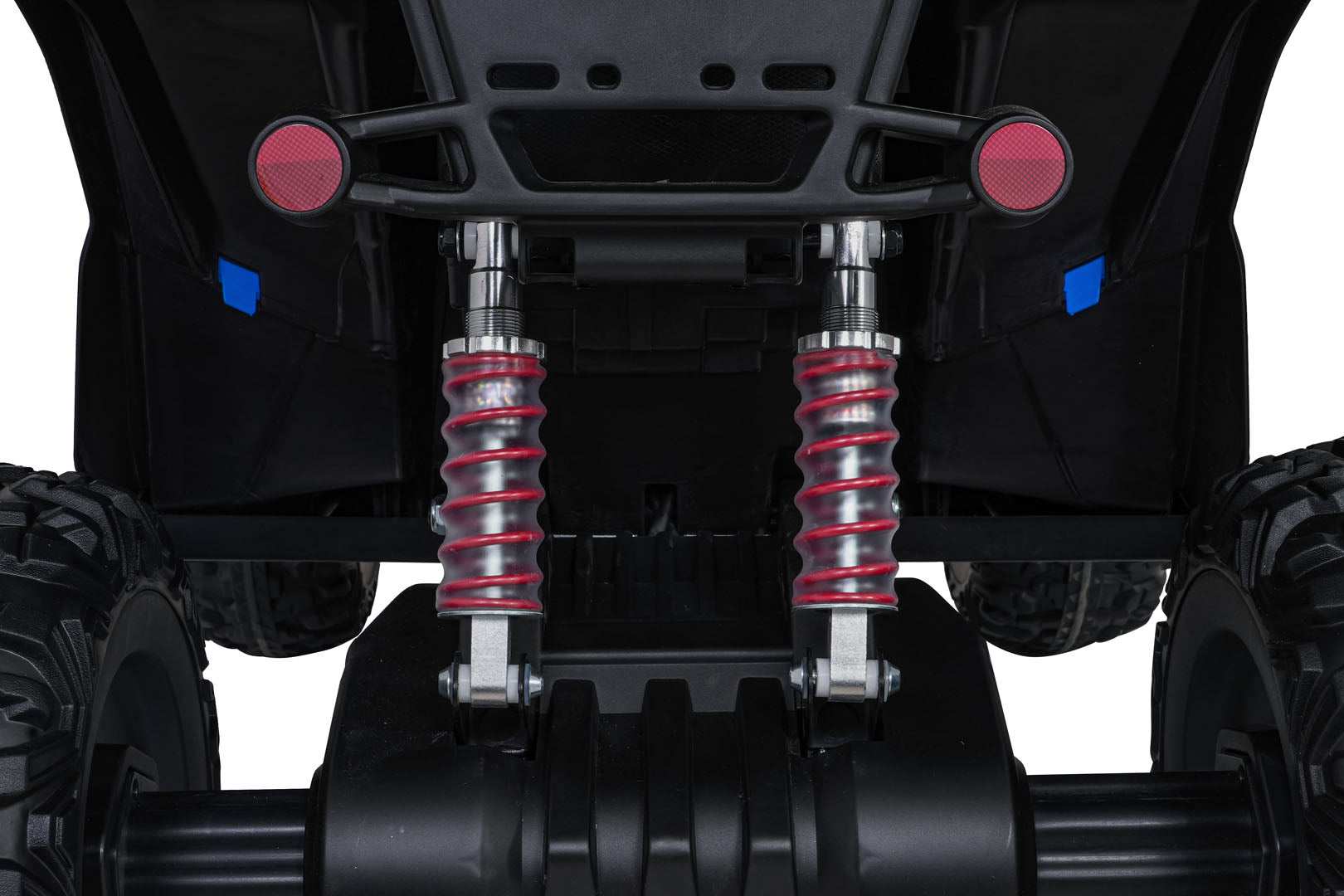 Close-up view of red coil rear shock absorbers and rugged wheels on Quad Fast Wheel kids' yellow ride-on toy