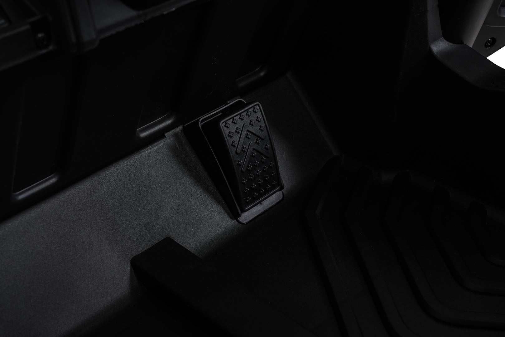 Close-up of black pedal on Buggy Madman UTV MX children's electric vehicle floorboard